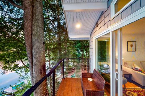 a balcony with a table and a tree at Bon Vie Chalet in Ludlow