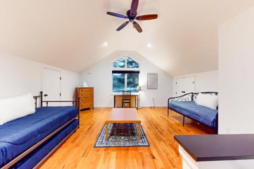 un soggiorno con 2 divani blu e un ventilatore a soffitto di Bon Vie Chalet a Ludlow