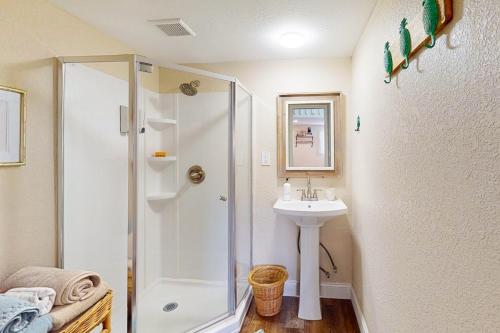 a bathroom with a shower and a sink at Bunglow Boogie Bunkhouse in New Port Richey