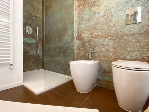 a bathroom with a toilet and a shower at At Fourth in Cagliari