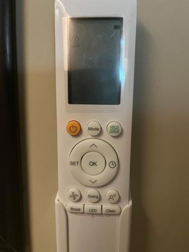 a white remote control sitting on top of a refrigerator at The Belmore in Sale