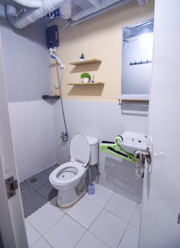 a bathroom with a toilet and a sink at GoldMine Staycation in Manila