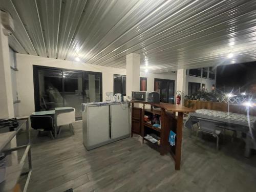 a room with a kitchen with a refrigerator and a table at Villa Blue Lodge in Saint-Louis