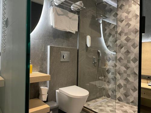 a bathroom with a toilet and a shower at Voula Hotel in Hersonissos