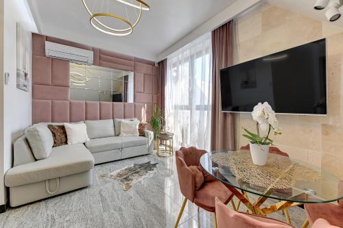 a living room with a couch and a table at GRANARIA Kingdom & Happiness Premium Apartments by the River in Gdańsk