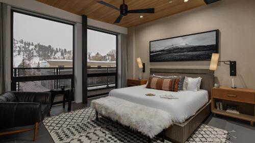 a bedroom with a large bed and a balcony at Butterfly Lofts - West in Steamboat Springs