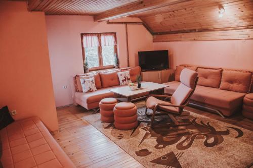 a living room with a couch and a table at Guest house SAMM in Šišava