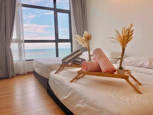 a bedroom with two beds and a large window at imperium residence kuantan in Kuantan