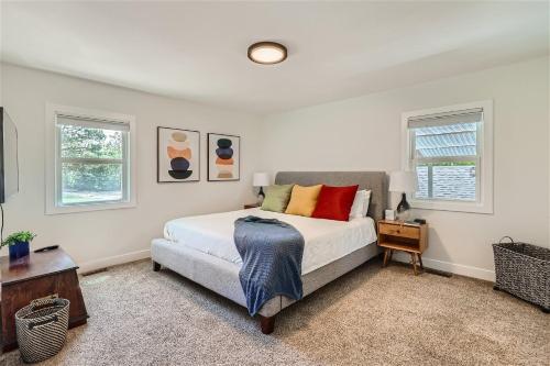a bedroom with a bed and two windows at 6224 S Datura St in Littleton