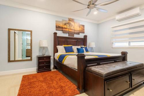 a bedroom with a bed and a ceiling fan at serendipity on the beach Ocho Rios in Saint Annʼs Bay