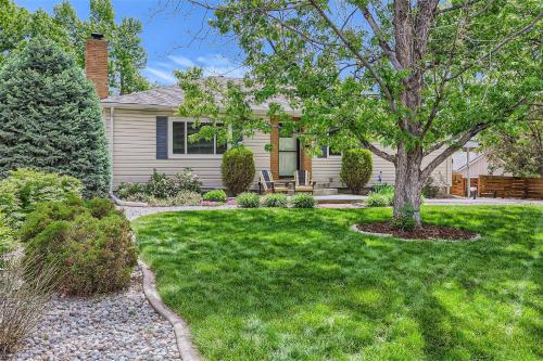 a home with a yard with a tree and grass at 6224 S Datura St in Littleton