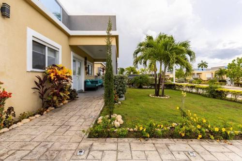 a house with a garden in front of it at serendipity on the beach Ocho Rios in Saint Annʼs Bay