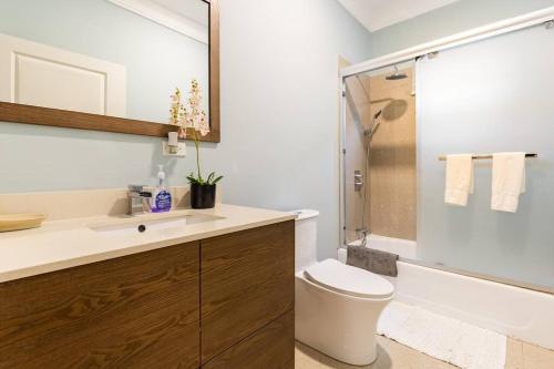 a bathroom with a toilet and a sink and a tub at serendipity on the beach Ocho Rios in Saint Annʼs Bay