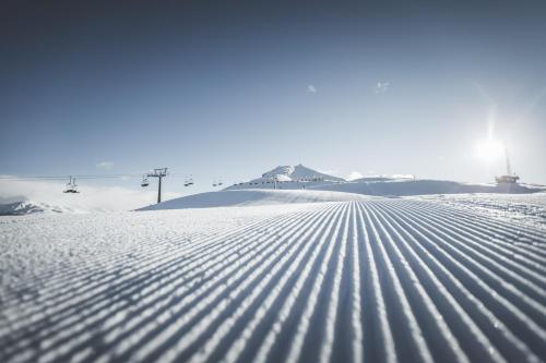 a snow covered slope with a ski lift in the background at Hotel Royal in Sesto