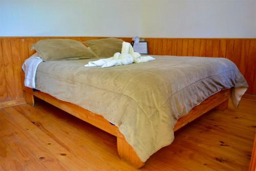a bed with two stuffed animals on top of it at Hostal Michel in Vicuña