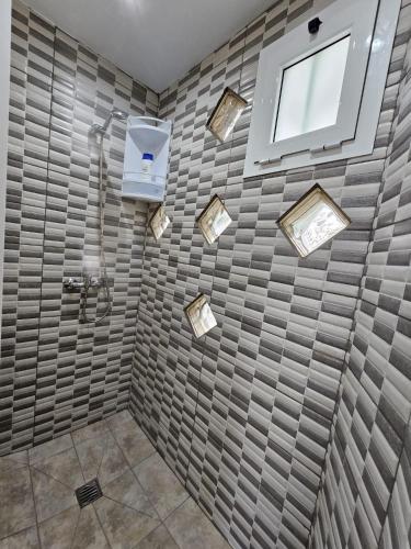a bathroom with a shower and a window at JUMA HOLIDAYS in Puerto del Carmen