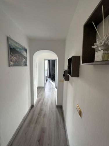 a hallway with white walls and a wooden floor at B&B il Rio in Anacapri
