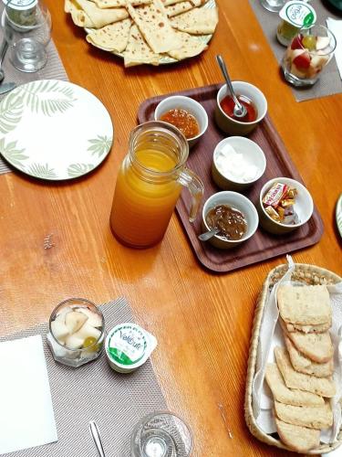 a wooden table topped with food and a jar of honey at La Maison des Amis in Fès