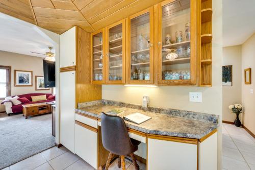 eine Küche mit einer Theke und einem Stuhl in der Unterkunft Spacious Beloit Retreat Close to Parks and Trails! in Beloit