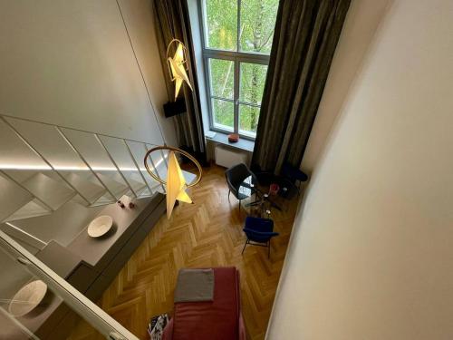 Cette suite offre une vue sur le plafond et dispose d'un salon avec une fenêtre. dans l'établissement Cosy loft in Kaunas center, à Kaunas