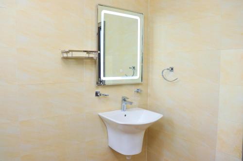 a bathroom with a sink and a mirror at Roseville in Nairobi