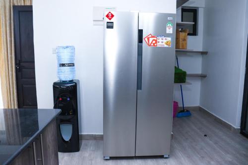 a stainless steel refrigerator in a kitchen with a blender at Roseville in Nairobi
