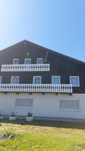 a black and white house with two windows at Ferienwohnung Eleni in Mauth