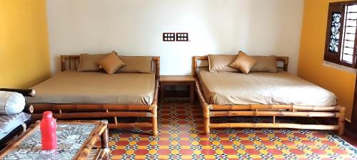 Mithila Eco Stay - Explore chettinad tesisinde bir odada yatak veya yataklar