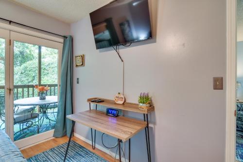 a living room with a table and a balcony at 2 Mi to Silver Dollar City Cozy Condo with Balcony! in Branson West