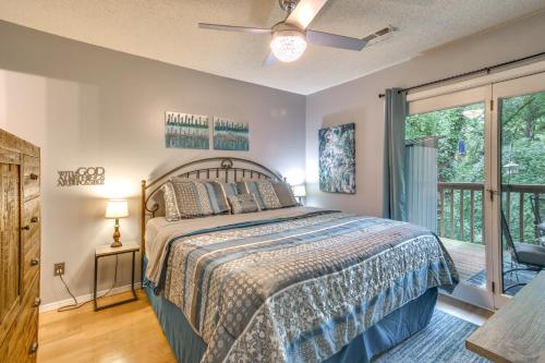 a bedroom with a bed and a sliding glass door at Branson West Condo 1 Mi to Silver Dollar City in Branson West