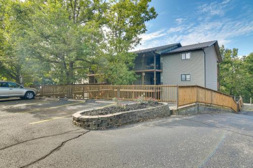 a house with a fence in a parking lot at 2 Mi to Silver Dollar City Cozy Condo with Balcony! in Branson West