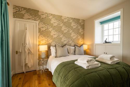 a bedroom with a bed with towels on it at Nether Glenny Farm in Stirling
