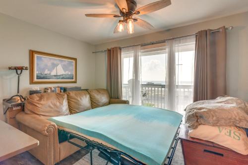 ein Wohnzimmer mit einem Sofa und einem Deckenventilator in der Unterkunft Beachfront Galveston Condo with Pool and Ocean Views! in Galveston