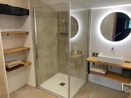 a bathroom with a shower and a sink at La Maison des Ecureuils - Bruniquel in Bruniquel