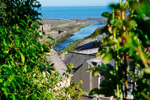 a view of the ocean from a hill with houses at Lynmouth View in Lynmouth