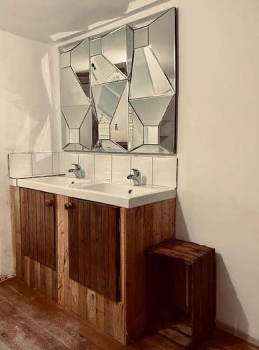 a bathroom with a sink and a mirror at A Casa da Bicicleta in Lousã