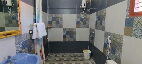 a bathroom with a shower with a sink and a toilet at Mithila Eco Stay - Explore chettinad in Mithilaipatti