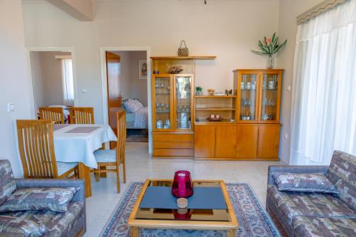 a living room with a couch and a table at Filoxenia House at Anemochori village in Pýrgos