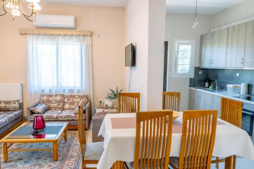 a kitchen and a living room with a table and chairs at Filoxenia House at Anemochori village in Pyrgos
