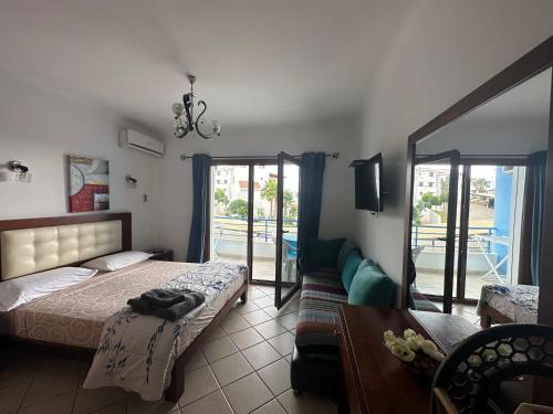 a bedroom with a bed and a couch and a tv at Appart-Hotel cabo dream in Cabo Negro