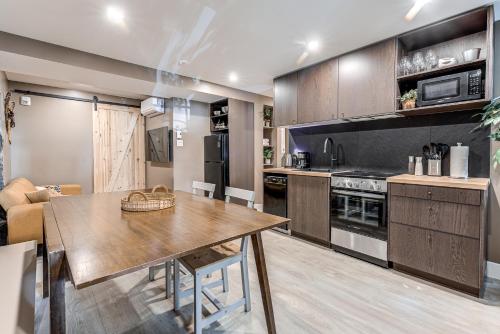 a kitchen with a wooden table and a dining room at North House - Beautiful Vieux 2 Bedroom Apt in Quebec City