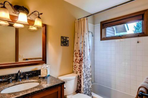 a bathroom with a sink and a toilet and a shower at Ravens Call Chalet in Breckenridge