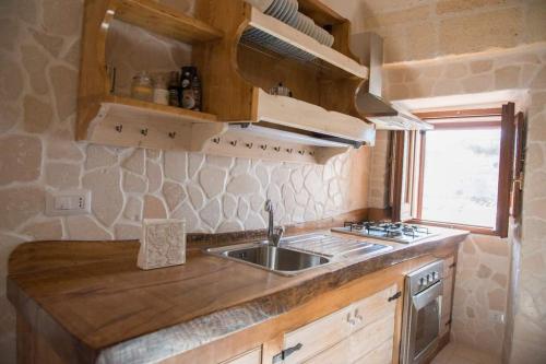 a small kitchen with a sink and a window at San Leonardo - ApartHotel in Laterza
