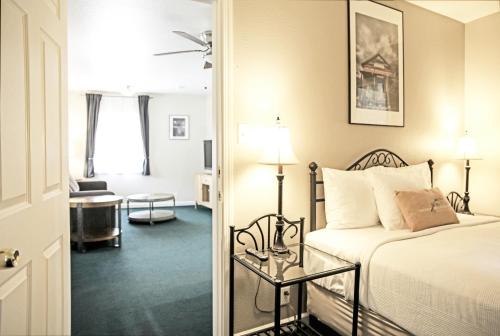 a bedroom with a bed and a living room at Sierra Mountain Inn in Grass Valley