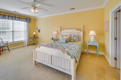 a bedroom with a bed and a ceiling fan at Bermuda Bay Home - Gated Oceanfront Community in Myrtle Beach
