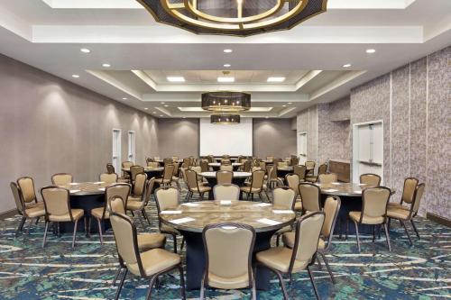 a conference room with tables and chairs and a chandelier at Hilton Garden Inn Houston Energy Corridor in Houston