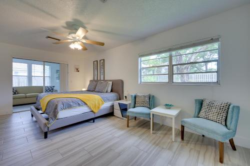 a bedroom with a bed and two chairs and a ceiling fan at Florida Vacation Rental Near Historic Downtown in St. Augustine