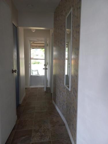 a hallway with a door and a tile floor at Sunshine Bayridge in Kingston