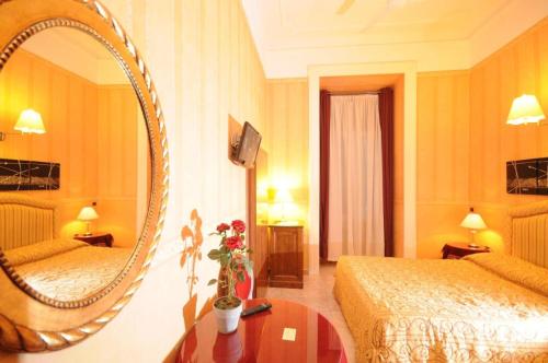 a hotel room with two beds and a mirror at HOTEL MILAZZO in Rome