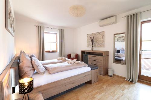 a bedroom with a bed and a dresser and a mirror at Naturtalente Berghaus - Apartment 4 in Innerschwand am Mondsee